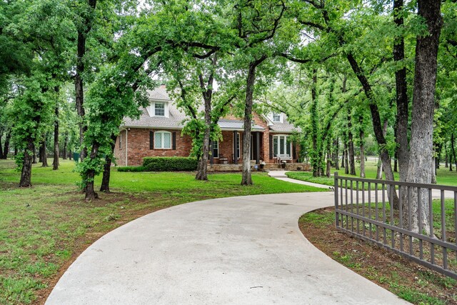 306 Stonecrest Rd, Argyle, TX 76226 - view of front facade featuring curved driveway, brick siding, and a porch