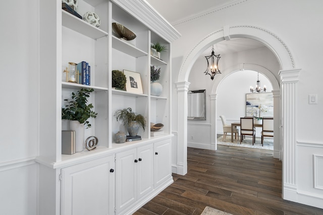 306 Stonecrest Rd, Argyle, TX 76226 - hall featuring a chandelier, arched walkways, decorative columns, dark wood finished floors, and crown molding