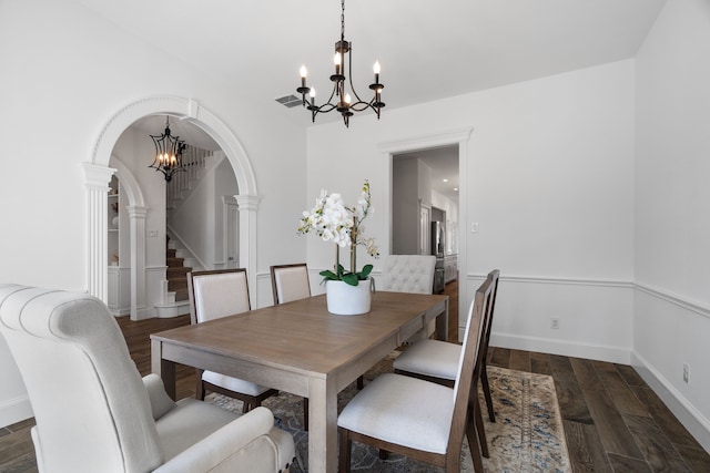 306 Stonecrest Rd, Argyle, TX 76226 - dining area featuring a chandelier, arched walkways, stairs, and wood finished floors