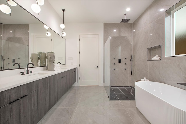 8506 Craighill Ave, Dallas, TX 75209 - full bathroom featuring marble tiled flooring, a tile shower, a freestanding tub, double vanity, and tile walls
