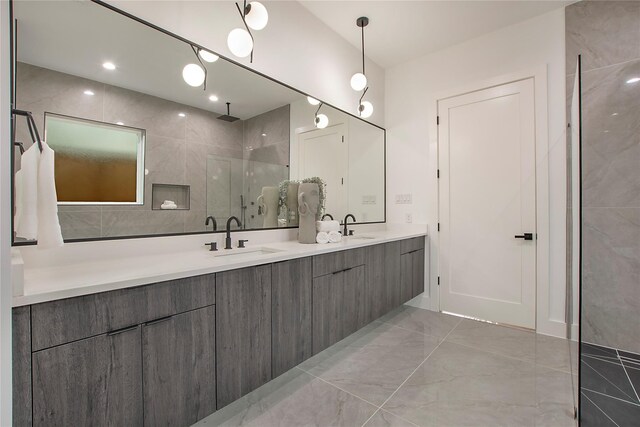 8506 Craighill Ave, Dallas, TX 75209 - bathroom featuring double vanity, a tile shower, and marble finish floors