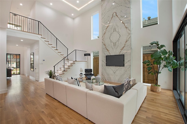 8506 Craighill Ave, Dallas, TX 75209 - living room with a high ceiling, wood finished floors, stairway, a high end fireplace, and recessed lighting