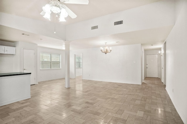 4629 Las Hadas, Mesquite, TX 75150 - unfurnished living room featuring decorative columns, a ceiling fan, a chandelier, baseboards, and a towering ceiling