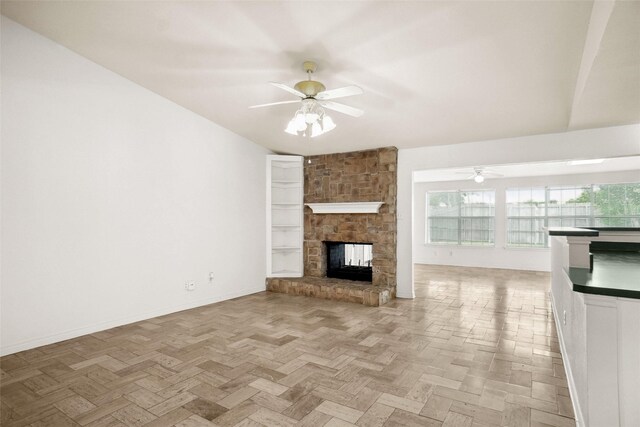 4629 Las Hadas, Mesquite, TX 75150 - unfurnished living room with ceiling fan, a stone fireplace, and baseboards