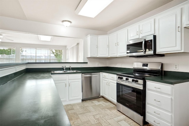 4629 Las Hadas, Mesquite, TX 75150 - kitchen featuring stainless steel appliances, a sink, dark countertops, and white cabinets