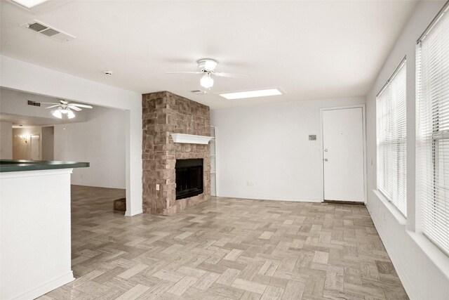 4629 Las Hadas, Mesquite, TX 75150 - unfurnished living room featuring ceiling fan, a fireplace, and baseboards