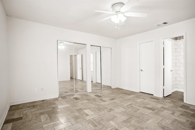 4629 Las Hadas, Mesquite, TX 75150 - unfurnished bedroom featuring multiple closets, baseboards, connected bathroom, and a ceiling fan