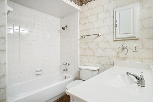 4629 Las Hadas, Mesquite, TX 75150 - full bathroom featuring bathing tub / shower combination, toilet, vanity, and tile walls