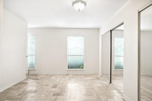 4629 Las Hadas, Mesquite, TX 75150 - unfurnished bedroom featuring baseboards and multiple closets