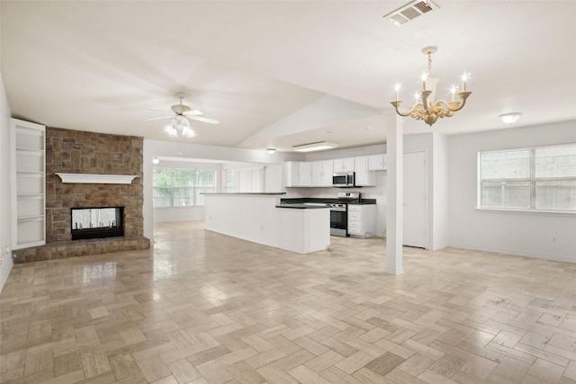 4629 Las Hadas, Mesquite, TX 75150 - unfurnished living room with a ceiling fan, a chandelier, baseboards, a stone fireplace, and lofted ceiling