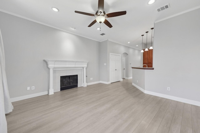 9718 Prestmont Pl, Frisco, TX 75035 - unfurnished living room with a ceiling fan, light wood finished floors, arched walkways, recessed lighting, and baseboards