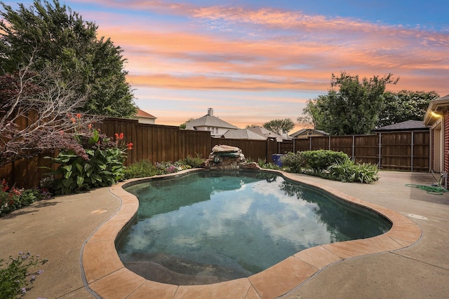 9718 Prestmont Pl, Frisco, TX 75035 - pool at dusk with a fenced backyard and a patio area