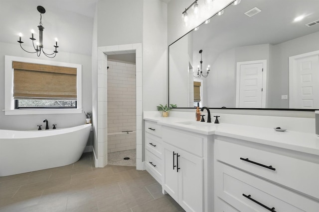 1020 Sky Rd, Weatherford, TX 76087 - bathroom with a chandelier, vanity, a freestanding tub, tile patterned flooring, and tiled shower