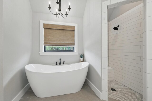 1020 Sky Rd, Weatherford, TX 76087 - bathroom featuring baseboards, a freestanding tub, a tile shower, a chandelier, and tile patterned floors