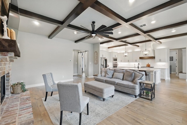 1020 Sky Rd, Weatherford, TX 76087 - living area with coffered ceiling, light wood-style floors, beamed ceiling, baseboards, and ceiling fan
