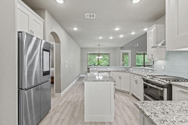 3723 Parkwood Ln, Denison, TX 75020 - kitchen featuring appliances with stainless steel finishes, white cabinetry, a peninsula, a sink, and recessed lighting