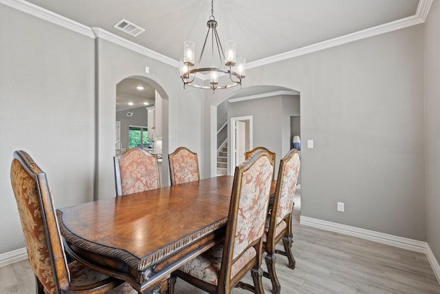 3723 Parkwood Ln, Denison, TX 75020 - dining space featuring arched walkways, a chandelier, baseboards, crown molding, and light wood-style floors