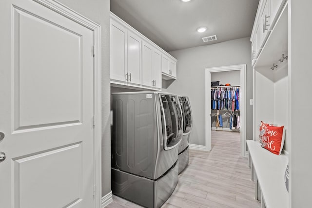 3723 Parkwood Ln, Denison, TX 75020 - washroom with separate washer and dryer, baseboards, light wood-style floors, recessed lighting, and cabinet space