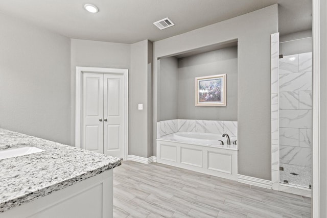 3723 Parkwood Ln, Denison, TX 75020 - full bath with a garden tub, a stall shower, vanity, and baseboards
