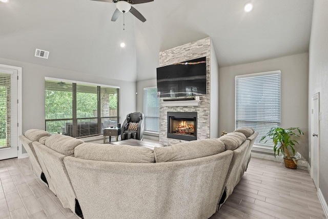 3723 Parkwood Ln, Denison, TX 75020 - living area with ceiling fan, a stone fireplace, baseboards, high vaulted ceiling, and light wood-style flooring