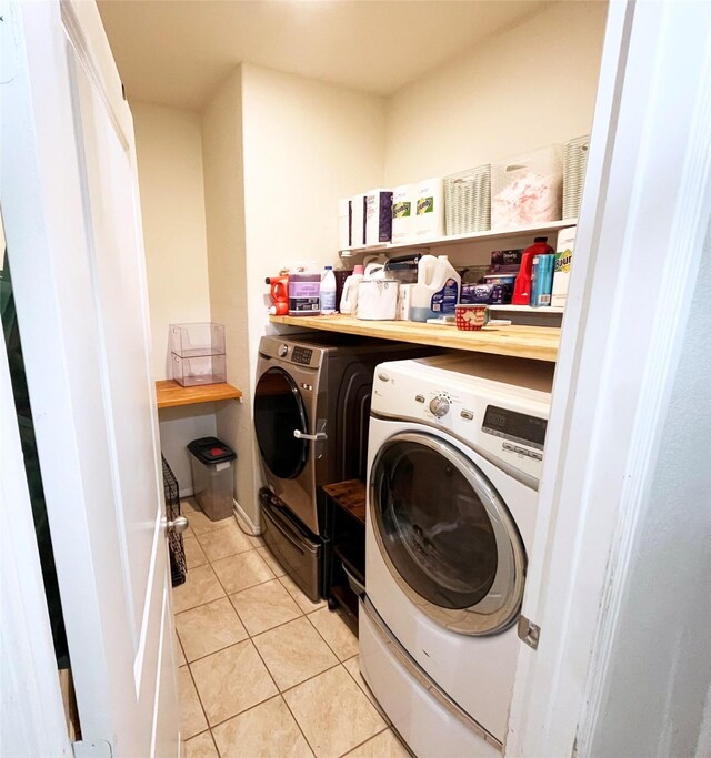 328 Foxhunter St, Fort Worth, TX 76131 - laundry area with washing machine and clothes dryer and light tile patterned floors