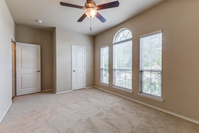 905 Ridge Dr, Little Elm, TX 75068 - unfurnished bedroom with multiple windows, carpet, and baseboards