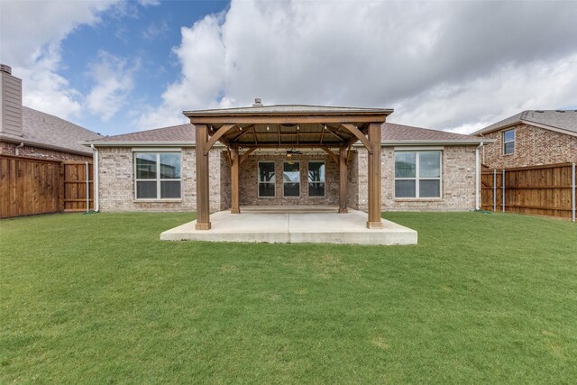 905 Ridge Dr, Little Elm, TX 75068 - back of house featuring a ceiling fan, a patio area, brick siding, a gazebo, and a shingled roof