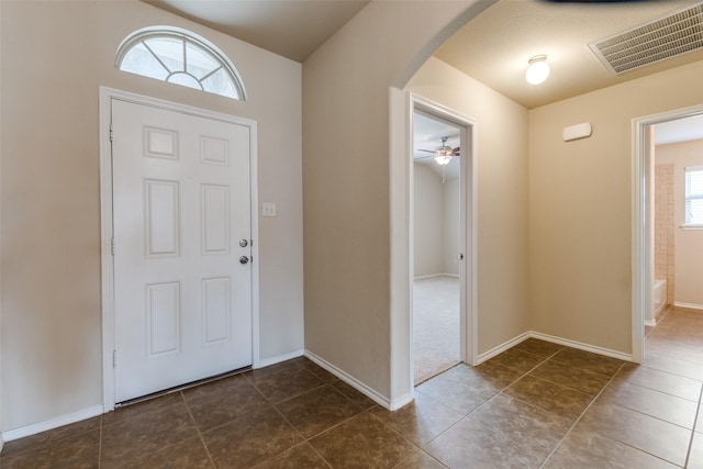 905 Ridge Dr, Little Elm, TX 75068 - entrance foyer with arched walkways, dark tile patterned floors, and baseboards