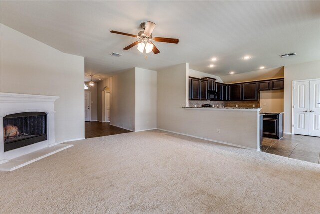 905 Ridge Dr, Little Elm, TX 75068 - unfurnished living room featuring carpet, ceiling fan, baseboards, recessed lighting, and a fireplace with raised hearth