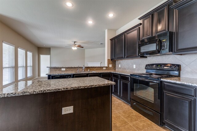 905 Ridge Dr, Little Elm, TX 75068 - kitchen with black appliances, a sink, backsplash, light stone counters, and recessed lighting