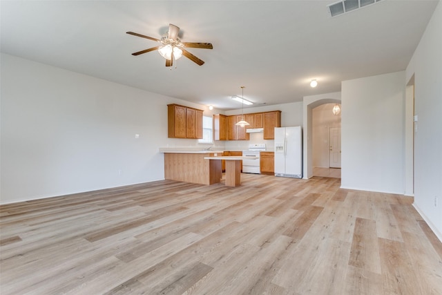 5132 Senator Dr, Fort Worth, TX 76244 - kitchen with white appliances, open floor plan, light countertops, arched walkways, and a peninsula