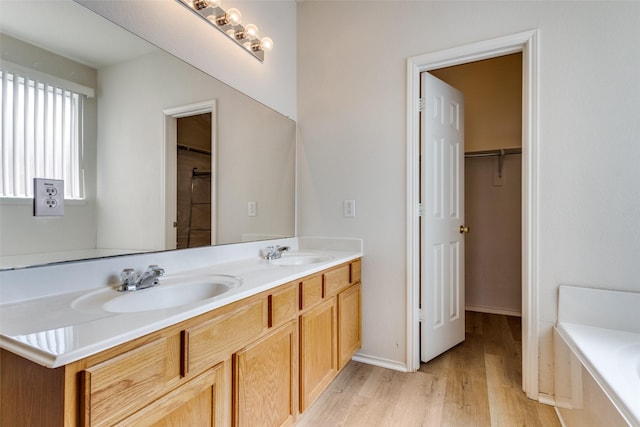 5132 Senator Dr, Fort Worth, TX 76244 - full bath featuring wood finished floors, double vanity, a bath, a spacious closet, and baseboards