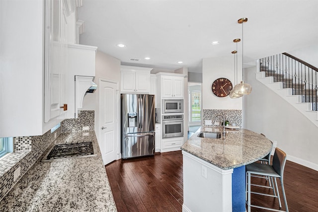 768 Telemark Trl, Frisco, TX 75036 - kitchen with appliances with stainless steel finishes, a sink, light stone countertops, dark wood-style flooring, and recessed lighting