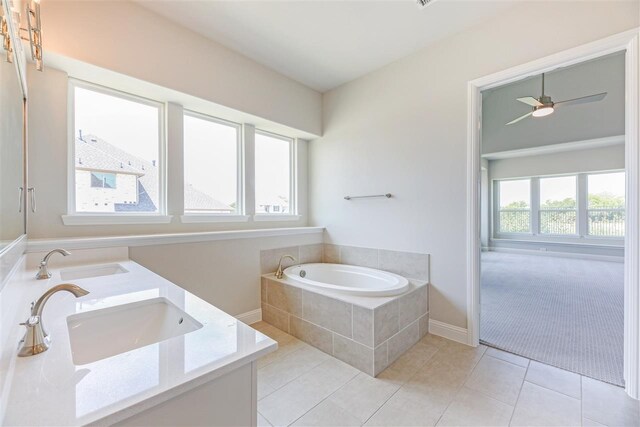 2207 Morris St, Rockwall, TX 75087 - bathroom featuring a garden tub, double vanity, tile patterned floors, and baseboards