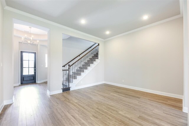2207 Morris St, Rockwall, TX 75087 - entrance foyer with stairway, a chandelier, light wood-type flooring, baseboards, and ornamental molding
