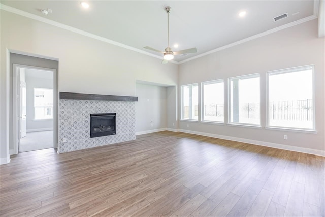 2207 Morris St, Rockwall, TX 75087 - unfurnished living room with healthy amount of natural light, baseboards, wood finished floors, and ornamental molding