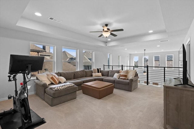 929 Lady Tessala Ave, Lewisville, TX 75056 - living room featuring a raised ceiling, a ceiling fan, light carpet, recessed lighting, and plenty of natural light