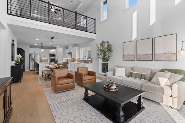 929 Lady Tessala Ave, Lewisville, TX 75056 - living room with a towering ceiling, light wood-type flooring, plenty of natural light, recessed lighting, and a ceiling fan
