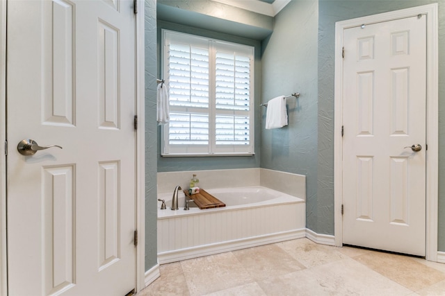 6305 Crested Butte Dr, Dallas, TX 75252 - bathroom featuring a garden tub, baseboards, and a textured wall