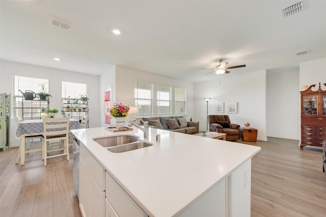 968 Manuel Dr, Fate, TX 75087 - kitchen featuring a sink, ceiling fan, a center island with sink, light wood-type flooring, and recessed lighting