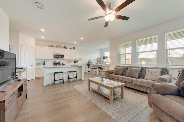968 Manuel Dr, Fate, TX 75087 - living room featuring a ceiling fan, recessed lighting, and light wood finished floors