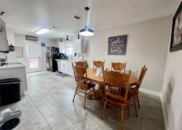 7208 Autumn Run Dr, Forest Hill, TX 76140 - dining space with a textured ceiling and baseboards
