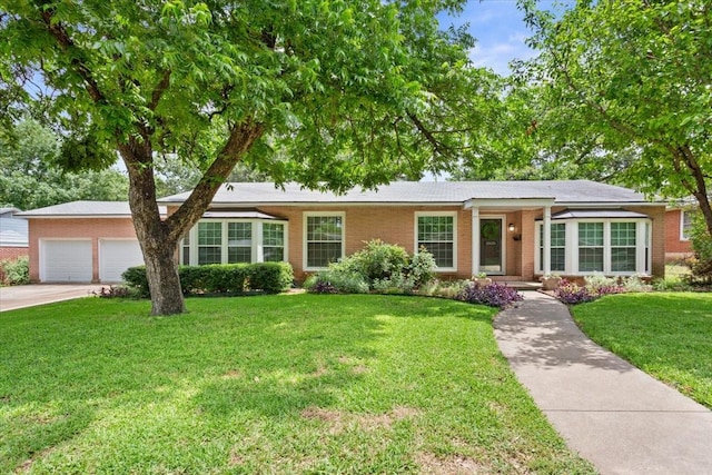 3808 Huaco Ln, Waco, TX 76710 - ranch-style home with brick siding, a garage, a front yard, and driveway