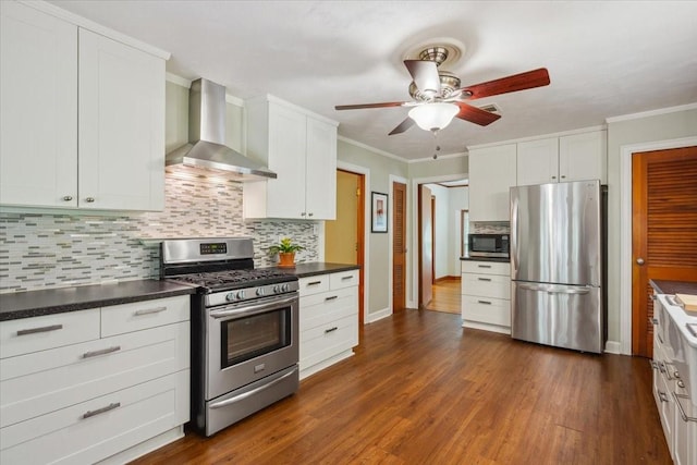 3808 Huaco Ln, Waco, TX 76710 - kitchen with stainless steel appliances, wall chimney range hood, ceiling fan, backsplash, and dark countertops