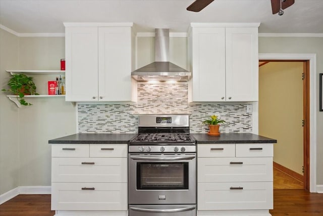 3808 Huaco Ln, Waco, TX 76710 - kitchen with stainless steel gas stove, wall chimney range hood, tasteful backsplash, white cabinetry, and crown molding