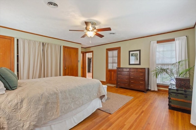 3808 Huaco Ln, Waco, TX 76710 - bedroom featuring multiple windows, light wood finished floors, ornamental molding, ceiling fan, and baseboards