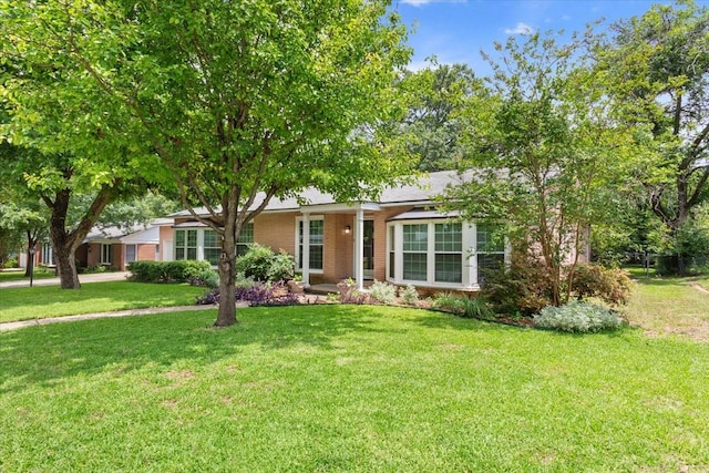 3808 Huaco Ln, Waco, TX 76710 - ranch-style home with a front yard and brick siding