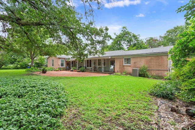 3808 Huaco Ln, Waco, TX 76710 - back of house with brick siding, a yard, and a patio
