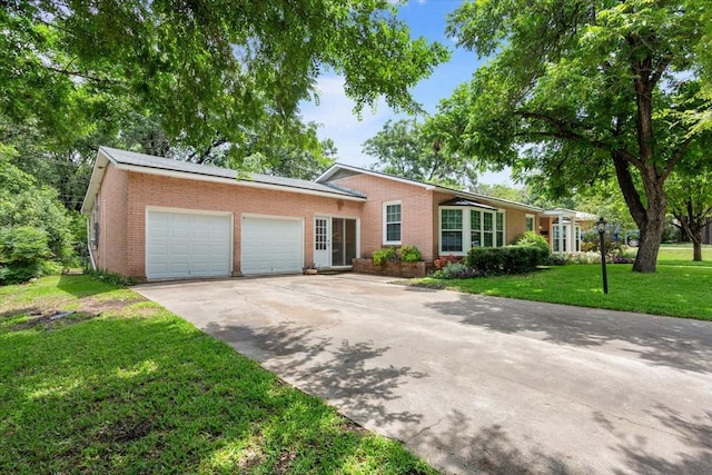 3808 Huaco Ln, Waco, TX 76710 - single story home with brick siding, an attached garage, driveway, and a front yard