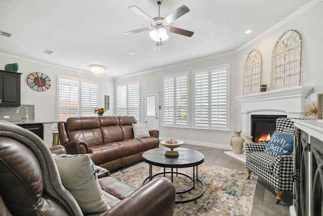 15236 Holly Bay Ct, Aledo, TX 76008 - living area featuring a lit fireplace, wood finished floors, a ceiling fan, crown molding, and recessed lighting